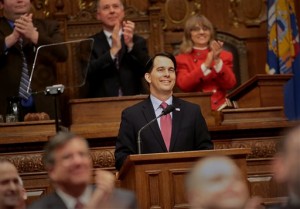 Members of the Legislature applaud Tuesday as Gov. Scott Walker delivers his state budget speech at the state Capitol in Madison. (AP Photo/Wisconsin State Journal, John Hart)