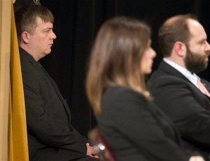 Fred police officer Christopher, left, listens as a panel of three Fire and Police Commission members at Centennial Hall uphold his dismissal Monday, March 23, 2015 in Milwaukee, Wis. Manney, who was fired after the fatal on-duty shooting of Dontre Hamilton, has maintained that he had done nothing wrong. (AP Photo/Milwaukee Journal-Sentinel, Mark Hoffman)