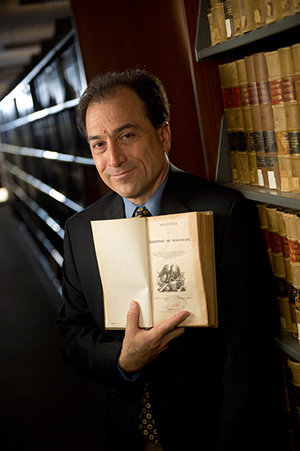 Marquette University Law School professor Ed Fallone holds a copy of “Statues of the Territory of Wisconsin” at the university’s law library. The book was printed in 1839, almost a decade before Wisconsin became a state. (Staff photo by Kevin Harnack)