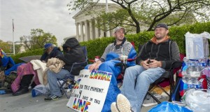 Sean Varsho, 28, of Chicago, left, and Brandon Dawson, 26, of Warrantor, Va., have been waiting in line for the past three days for a seat for Tuesday's Supreme Court hearing on gay marriage, Monday, April 27, 2015, in Washington. The opponents of same-sex marriage are urging the court to resist embracing what they see as a radical change in society's view of what constitutes marriage. (AP Photo/Cliff Owen)