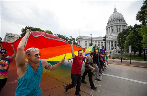 People celebrate on the Capitol Square in Madison, Wis., Friday, June 26, 2015. Gay marriage has been legal in Wisconsin for months, but supporters still trumpeted a U.S. Supreme Court ruling Friday legalizing same-sex marriage nationwide with relief and joy, saying it cements same-sex unions in the state. (AP Photo/Wisconsin State Journal, Steve Apps)