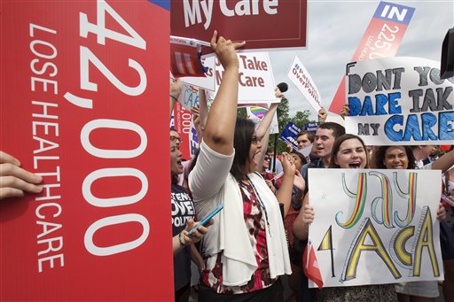 Jessica Ellis, right, with "yay 4 ACA" sign, and other supporters of the Affordable Care Act, react with cheers as the opinion for health care is reported outside of the Supreme Court in Washington,Thursday June 25, 2015. The Supreme Court on Thursday upheld the nationwide tax subsidies under President Barack Obama's health care overhaul, in a ruling that preserves health insurance for millions of Americans. (AP Photo/Jacquelyn Martin)