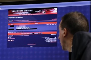 FBI Supervisory Special Agent J. Keith Mularski, who heads the cybercrime squad at the agency’s Pittsburgh field office, displays a screen shot from the Darkcode website, top left, an English-language "marketplace for cybercriminals", at the National Cyber-Forensics & Training Alliance in Pittsburgh, Tuesday, July 14, 2015. The Justice Department has targeted more than 70 alleged cybercrimals in 20 countries who've been using Darkcode, a members-only online marketplace to buy and sell hacked databases, malicious software and other "products" that can cripple or steal information from computer systems. U.S. Attorney David J. Hickton of the Western District of Pennsylvania announced Wednesday in Pittsburgh that the computer hacking forum known as Darkcode was dismantled Wednesday, and criminal charges have been filed against 12 individual associated with the forum. (AP Photo/Gene J. Puskar)
