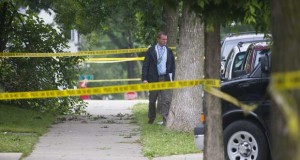 Authorities work the scene of a double homicide in Milwaukee on July 7. The city has already surpassed the total number of homicides it experienced in 2014, leaving officials scrambling to find answers. (Mark Hoffman/Milwaukee Journal Sentinel via AP)
