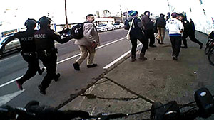 In this image from video taken from a Seattle police body camera, Seattle police officers move in to make an arrest during a Black Lives Matter demonstration in January.  (Seattle Police Department via AP)