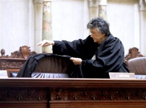 Wisconsin Supreme Court Justice Shirley Abrahamson places a judicial robe on the chair of the late Justice N. Patrick Crooks following a moment of silence in the court in the Wisconsin State Capitol in Madison, Wis. Tuesday, Sept. 22, 2015. Crooks died unexpectedly in his chambers on Monday afternoon. (John Hart/Wisconsin State Journal via AP)