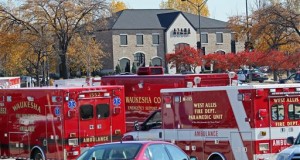 emergency vehicles in front of the Azana Salon & Spa after a shooting in Brookfield, Wis. A wrongful death lawsuit has been filed against a company that helped obtain a gun for a man who killed three women, including his estranged wife, and wounded four others at the suburban Milwaukee salon before killing himself. (Michael Sears/Milwaukee Journal-Sentinel via AP)