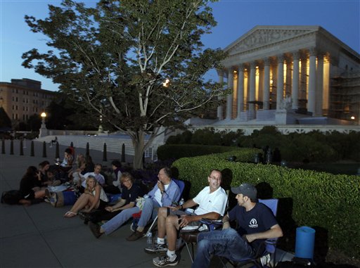 people line up in front of the U.S. Supreme Court on the eve of the expected ruling on whether or not the Affordable Care Act passes the test of constitutionality in Washington. The Supreme Court on Oct. 5, 2015, put a change in place that prohibits lawyers who are members of the Supreme Court bar from hiring "line standers" to hold their place for seats to big arguments. The practice is common for congressional hearings, and has become more so in recent years for high-profile high court cases, including those involving gay marriage and the Obama health care overhaul. Lawyers who are part of the Supreme Court bar have access to a reserved section toward the front of the courtroom, and their odds of getting in are better than those for the general public. But now they will have to wait in line themselves if they want seats in the special section. (AP Photo/Alex Brandon, File)