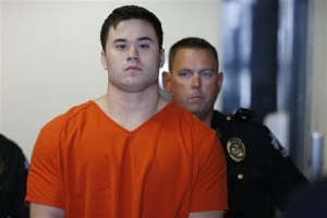 Daniel Holtzclaw, front, a former Oklahoma City police officer accused of sexual offenses against 13 women he encountered while on patrol, is led into a courtroom for a hearing in Oklahoma City. Holtzclaw's trial is set to begin on Monday, Nov. 2. (AP Photo/Sue Ogrocki, File)