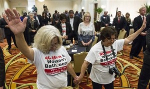 Rita Palomarez, left, and Linda Rodriguez pray during an election watch party attended by opponents of the Houston Equal Rights Ordinance on Tuesday, Nov. 3, 2015, in Houston. The ordinance that would have established nondiscrimination protections for gay and transgender people in Houston did not pass. (Brett Coomer/Houston Chronicle via AP)