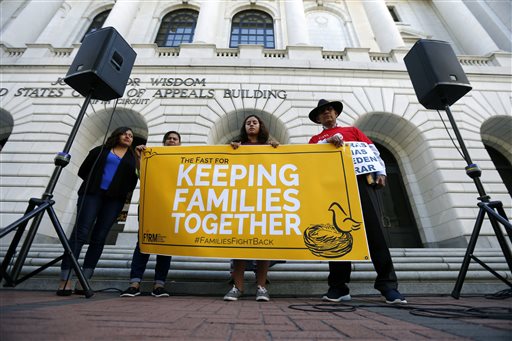 Immigration activists protest outside the federal appeals court in New Orleans, Wednesday, Oct. 14, 2015. The activists are accusing the federal appeals court in New Orleans of delaying a ruling about President Barack Obama's immigration proposal in an effort to prevent it from reaching the U.S. Supreme Court during the current term. Left to right are Nora Hernandez, of Albuquerque, N.M., Myrta Venture, of Silver Spring, Md., Mayra Jannet Ramierz, of Mountain Hope, Ark. and Miguel H. Claros, of Silver Spring. (AP Photo/Gerald Herbert)
