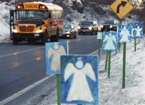 a bus traveling from Newtown, Conn., to Monroe stops near 26 angel signs posted along the roadside in Monroe, Conn., on the first day of classes for Sandy Hook Elementary School students since the Dec. 14, 2012, shooting. The massacre in Newtown, in which a mentally troubled young man killed 26 children and teachers, served as a rallying cry for gun-control advocates across the nation. But in the three years since, many states have moved in the opposite direction, embracing the National Rifle Association’s axiom that more “good guys with guns” are needed to deter mass shootings. (AP Photo/Jessica Hill, File)