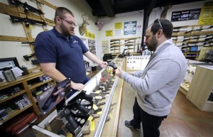 Mike Howse, left, helps David Foley as he shops for a handgun at the Spring Guns and Ammo store Monday, Jan. 4, 2016, in Spring, Texas. President Barack Obama defended his plans to tighten the nation's gun-control restrictions on his own, insisting Monday that the steps he'll announce fall within his legal authority and uphold the constitutional right to own a gun. (AP Photo/David J. Phillip)