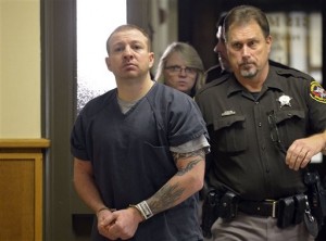 Andrew Obregon, left, enters Judge Chad Kerkman's courtroom escorted by Kenosha County Sheriff's deputies on Thursday, Jan. 21, 2016, in Kenosha, Wis. Obregon has been accused of killing Tywon Anderson in September then going on the run and eluding capture for weeks before he was arrested in Illinois. He has pleaded not guilty to the 32 charges he faces in connection with the case. (Brian Passino/Kenosha News via AP)