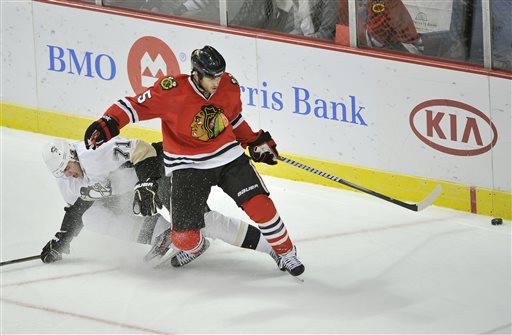 Chicago Blackhawks defenseman Steve Montador, right, and Pittsburgh Penguins center Evgeni Malkin, of Russia, go for the puck during the first period of a preseason NHL hockey game, in Chicago. Montador is among a group of plaintiffs in a lawsuit brought against the NHL over concussion repercussions that has grown to well over 100 former players, who believe the league ignored a duty to warn them of the risks of head injuries. (AP Photo/Brian Kersey, File)