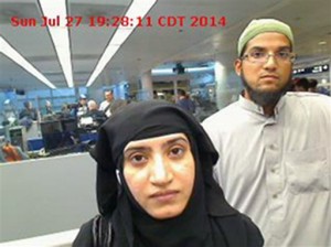 Tashfeen Malik (left) and Syed Farook are pictured as they pass through O’Hare International Airport in Chicago in 2014. A U.S. magistrate has ordered Apple to help the Obama administration hack into an iPhone belonging to one of the shooters in San Bernardino, Calif. (U.S. Customs and Border Protection via AP)