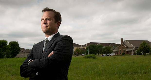 Murphy Desmond attorney Matthew Fleming stands in a vacant lot adjacent to McKee Park in Fitchburg. Fleming is representing the property owner in McKee Family I LLC v. City of Fitchburg and has been arguing that his client should prevail under standards established by the U.S. Supreme Court. (Staff photo by Kevin Harnack)