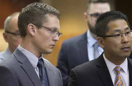 Joshua Larson, left, listens as his attorney Julius Kim, right, speaks to reporters after a preliminary hearing Tuesday, June 7, 2016, in Milwaukee County Court in Milwaukee, Wis. Larson has pleaded not guilty to charges stemming from a crash that killed two men after the Brewers opener. (Mark Hoffman/Milwaukee Journal-Sentinel via AP) 