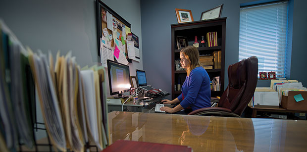 Courtney Graff responds to emails while working at Schmiege & Graff Law Office in Medford. “My pros might be other people’s cons,” Graff says about working in a small town. (Staff photo by Kevin Harnack)
