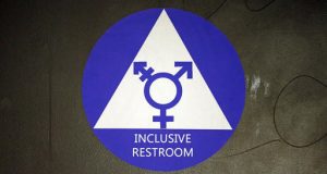 FILE - In this May 17, 2016, file photo, a new sticker designates a gender neutral bathroom at Nathan Hale high school in Seattle. A federal judge in Texas is blocking for now the Obama administration's directive to U.S. public schools that transgender students must be allowed to use the bathrooms and locker rooms consistent with their chosen gender identity. (AP Photo/Elaine Thompson, File)
