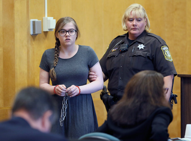 Morgan Geyser is led into the courtroom at Waukesha County Court, Friday, Aug. 19, 2016 in Waukesha, Wis. Geyser, one of two girls accused of trying to kill a 12-year-old classmate to please horror character Slender Man two years ago pleaded not guilty Friday by reason of insanity. (Michael Sears/Milwaukee Journal-Sentinel via AP)