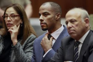 FILE - In this March 23, 2015, file photo, former NFL safety Darren Sharper, center, with his attorneys, Lisa Wayne, left, and Leonard Levine, right, appear in Los Angeles Superior Court. Sharper has been sentenced to 18 years in prison in a case where he was accused of drugging and raping as many as 16 women in four states. Judge Jane Triche Milazzo sentenced Sharper on Thursday, Aug. 18, 2016, in New Orleans.  (AP Photo/Nick Ut, Pool, File)