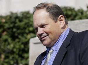 FILE - In this Sept. 9, 2015, file photo, former Multi-State Lottery Association security director Eddie Tipton leaves the Polk County Courthouse in Des Moines, Iowa, after his sentencing in a jackpot-fixing scandal. A judge says the winner of a Hot Lotto jackpot can continue a lawsuit that contends he would have won millions more if the prior drawing had not been rigged by a lottery vendor. Judge Karen Romano has rejected requests to dismiss the case, which is the first filed against the Multi-State Lottery Association over a jackpot-rigging scandal inside the organization. (AP Photo/Charlie Neibergall, File)