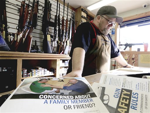 ADVANCE FOR RELEASE SATURDAY, NOVEMBER 19, 2016, AT 12:01 A.M. CST. AND THEREAFTER - In this Nov. 7, 2016 photo, Chuck Lovelace, owner of Essential Shooting Supplies in Mount Horeb, Wis., participates in the Gun Shop Project, a new effort by Safe Communities of Madison-Dane County to enlist the help of gun shop owners in preventing suicide. The program also encourages gun shop customers to store firearms away from home if a household member is having a mental health crisis. (John Hart/Wisconsin State Journal via AP)