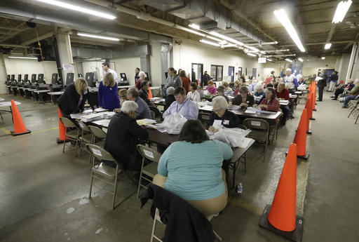 Workers begin a statewide presidential election recount Thursday, Dec. 1, 2016, in Milwaukee. The first candidate-driven statewide recount of a presidential election in 16 years began Thursday in Wisconsin, a state that Donald Trump won by less than a percentage point over Hillary Clinton after polls long predicted a Clinton victory. (AP Photo/Morry Gash)
