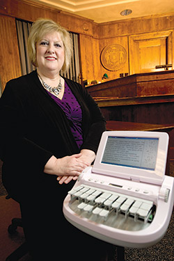 Sheri Piontek, a court reporter in Brown County, shows off a stenotype machine in a courtroom in Green Bay on Friday.