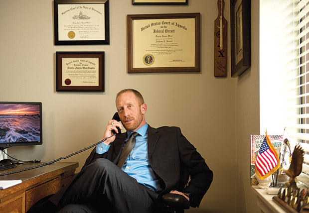 STAFF PHOTO BY KEVIN HARNACK Attorney Travis West talks with a client in his Waunakee office. Until a decade ago, attorneys could not make a living solely concentrating on veterans’ law, but “You’re slowly starting to see attorneys filter into this area of law,” West says.