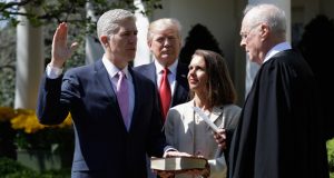President Donald Trump watches as U.S. Supreme Court Justice Anthony Kennedy administers the judicial oath to Justice Neil Gorsuch in the Rose Garden of the White House in Washington, D.C., on April 10. (AP File Photo/Evan Vucci)