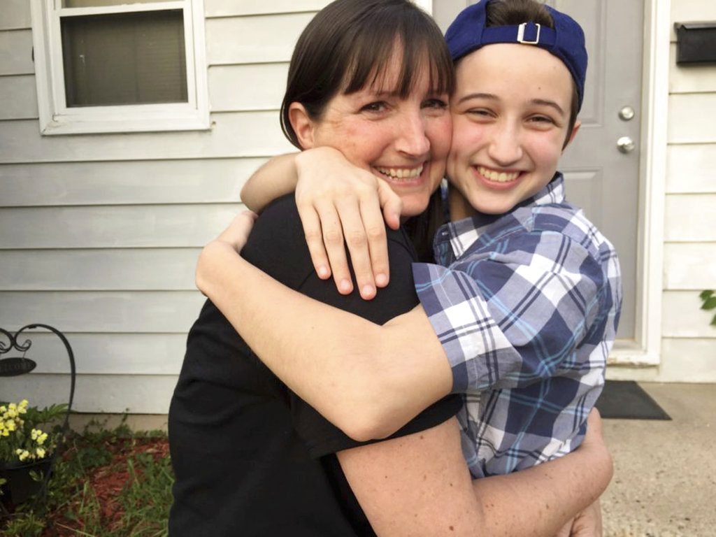 Ashton Whitaker, right hugs his mom Melissa in Kenosha, Wisc. A federal appeals court says Ashton, a transgender senior student, who identifies as a male, should be able to use the boys' bathroom at at Kenosha's Tremper High School. (Transgender Law Center via AP)