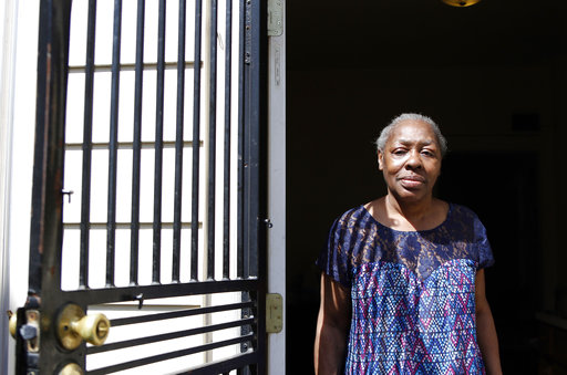 Gladys Harris stands in her doorway in Milwaukee on April 24. She was unable to vote in the November presidential election because she had lost her driver's license a few days before and thought one of the many other cards she had with her would work. She was given a provisional ballot but was unable to return with a proper ID in time. (AP Photo/Carrie Antlfinger)