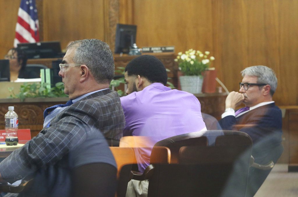 Dominique Heaggan-Brown, center, with defense attorneys Steven Kohn, left, and Jonathan Smith, appears in court as Milwaukee District Attorney John Chisholm presents his opening statement for the trial of Heaggan-Brown in Milwaukee on Tuesday, June 13, 2017. Chisholm, who charged Heaggan-Brown, a former Milwaukee police officer with killing a black man who fled a traffic stop last year, told a jury Tuesday the man was unarmed and defenseless when the officer shot him "point blank." (Michael Sears/Milwaukee Journal-Sentinel via AP)