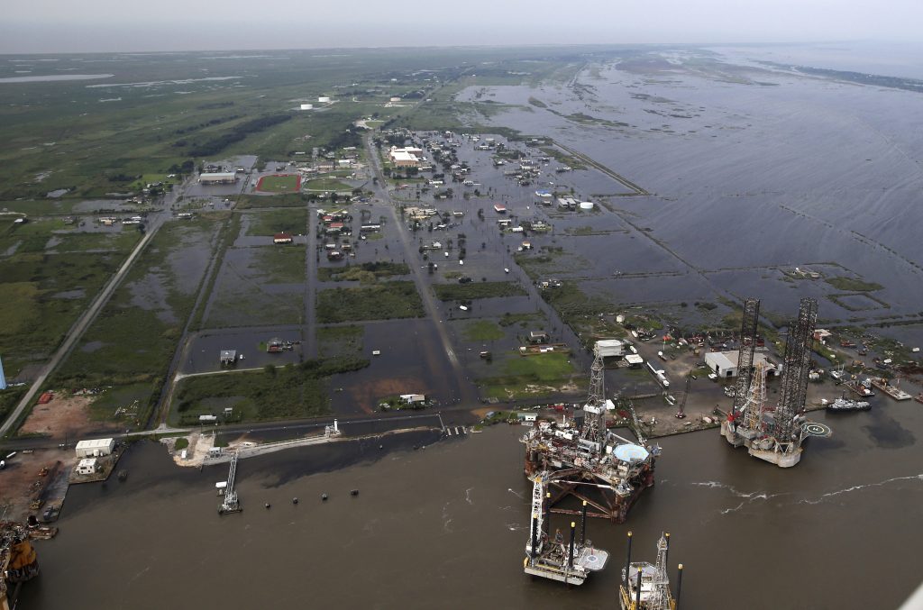 Flooding from Tropical Storm Harvey surrounds buildings in Sabine Pass, Texas, next to the Gulf of Mexico, Thursday. (AP Photo/Gerald Herbert)
