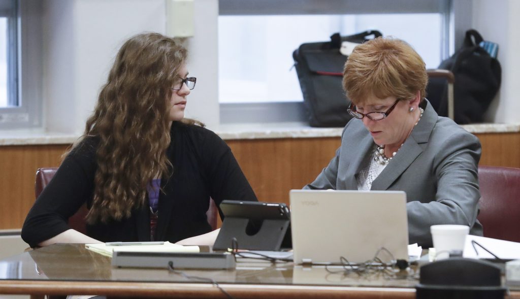 Anissa Weier, left, talks to her attorney Maura McMahon on Monday at the Waukesha County Courthouse during jury selection in a trial being held to determine the 15-year-old Weier's competency. Prosecutors allege that Weier and her friend, Morgan Geyser, lured their classmate Payton Leutner into a park in Waukesha in May 2014 and stabbed her 19 times. The girls have said the attack was an attempt to please a fictional horror character known as Slender Man. (AP Photo/Morry Gash, Pool)