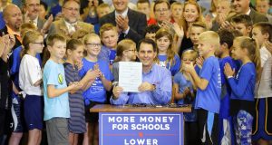 Governor Scott Walker signs the 2017-2019 state budget bill into law Thursday, Sept. 21, 2017, at Tullar Elementary School in Neenah, Wis. (Dan Powers/The Post-Crescent via AP)