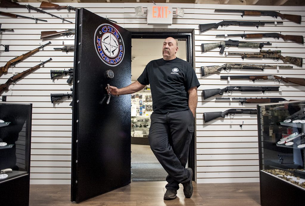 Chris Endres,  an owner of CTR Firearms, in Janesville, speaks on Oct. 31 about the vault used at his store to display guns and keep them secure. (Angela Major/The Janesville Gazette via AP)