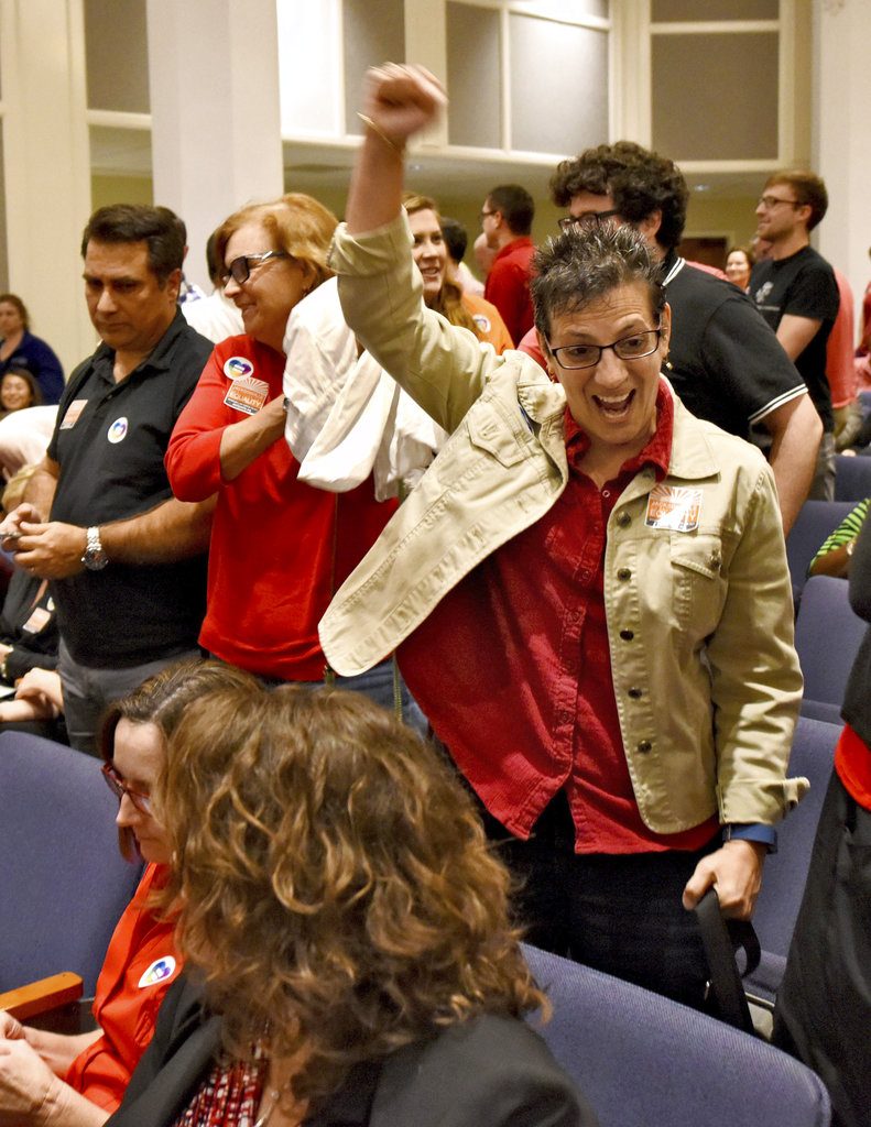 In this Tuesday Feb. 14, 2017 photo, Gloria Perino celebrates after after the Jacksonville City Council voted 12-6 to support the Human Rights Ordinance (HRO) in Jacksonville, Fla. At the U.S. Capitol, and in most statehouses nationwide, supporters of LGBT rights are unable to make major gains these days. Instead, they're notching victories in scores of cities and towns that have acted on their own in Republican-governed states. (Bob Mack/Florida Times-Union via AP)