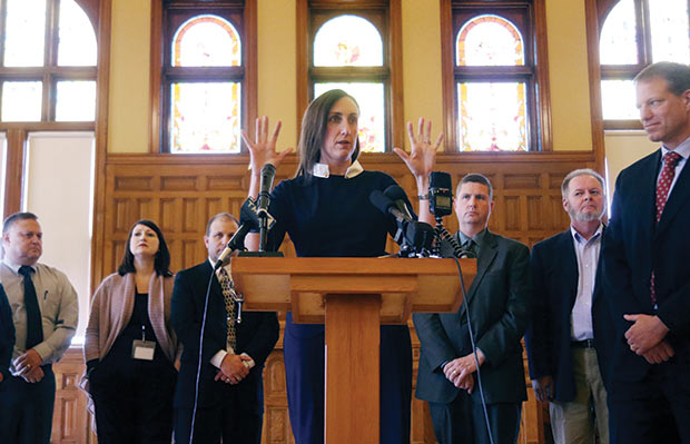 Erin Dickinson, a lawyer at Crueger Dickinson, gestures as she answers questions on Nov. 7 at the old courthouse museum in West Bend during a press conference announcing that 28 counties in Wisconsin have filed lawsuits against pharmaceutical companies. Dickinson said the counties would be looking to recoup money to pay for services designed to help opioid addicts. (Photo by John R. Ehlke/West Bend Daily News via AP)