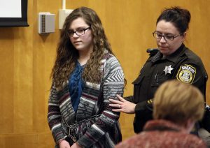 FILE - In this Dec. 21, 2017, file photo, Anissa Weier, one of two Wisconsin girls who tried to kill a classmate to win favor with a fictional horror character named Slender Man, is led into Court for her sentencing hearing, in Waukesha, Wis. She was sentenced to 25 years in a mental hospital, the maximum punishment possible. Their cases were selected as one of the biggest stories in the state over the last 12 months. (Michael Sears/Milwaukee Journal-Sentinel via AP, File)