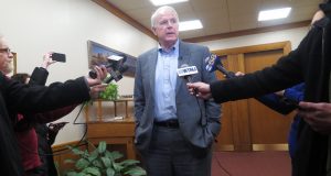 Milwaukee Mayor Tom Barrett speaks to reporters outside his office about the Red Cross asking fire victims in some parts of the city to come to them or a nearby police station on Tuesday, Jan. 2, 2018, in Milwaukee. The Red Cross Milwaukee chapter said the policy change is to address a volunteer shortage, but the move has sparked outrage because the areas affected are low-income and predominantly black and Latino. (AP Photo/Ivan Moreno)