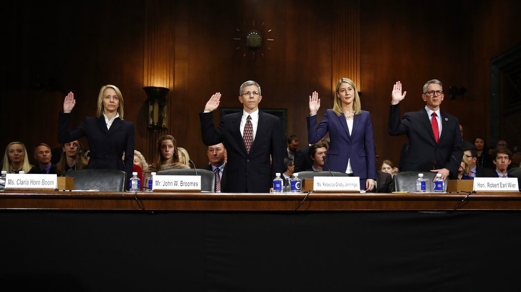 FILE - In this Nov. 15, 2017, file photo, four of President Donald Trump’s nominees to be district court judges are sworn in to testify before the Senate Judiciary Committee, from left, Claria Horn Boom, John Broomes, Rebecca Grady Jennings, and Robert Earl Wier, are sworn in to testify during a Senate Judiciary Committee on Capitol Hill in Washington. If confirmed, the nominees are invited to attend a new judge training affectionately called Baby Judges School. (AP Photo/Carolyn Kaster, File)