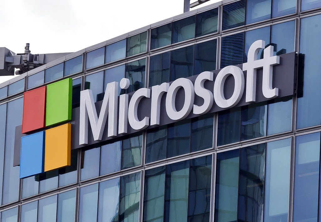 FILE - This April 12, 2016, file photo shows the Microsoft logo in Issy-les-Moulineaux, outside Paris, France. The budget bill before Congress includes an update to federal law that makes clear that authorities with a warrant can obtain emails and other data held by U.S. technology companies but stored on servers overseas. Passage of the Cloud Act probably would end a Supreme Court dispute between Microsoft and the Trump administration over emails the U.S. wants as part of a drug trafficking investigation. (AP Photo/Michel Euler, File)