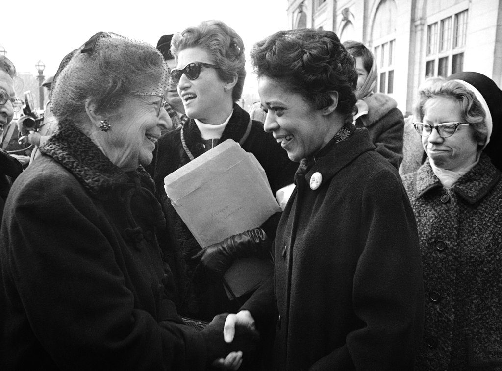 FILE - In this Jan. 16, 1968, file photo, Milwaukee alderman Vel Phillips, right, is greeted on her arrival to participate in a protest march in Washington by Jeanette Rankin, former Montana congresswoman and leader of the protest march. Phillips, a civil rights pioneer who helped lead open housing marches in Milwaukee in the 1960s and was the first black person elected to statewide office in Wisconsin, died Tuesday, April 17, 2018, in hospice care. She was 94. (AP Photo/Henry Burroughs, File)
