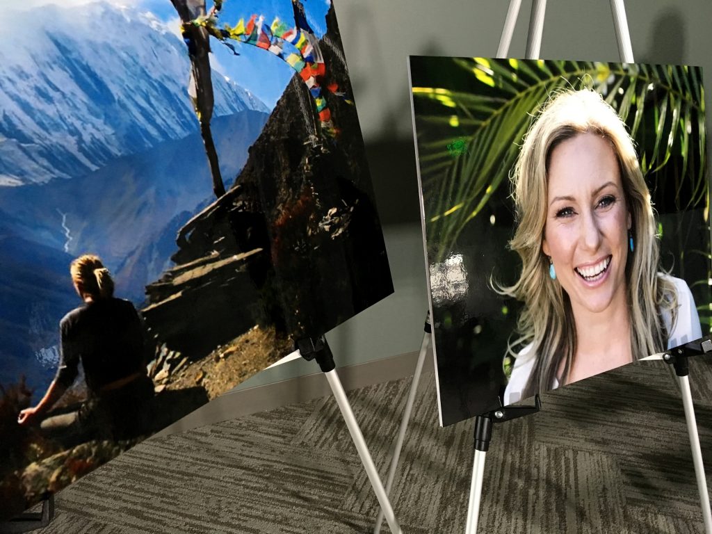 Posters of Justine Ruszczyk Damond are displayed Monday, July 23, 2018, at a news conference by attorneys for her family in Minneapolis. Family members of Damond, an Australian woman who was killed July 15, 2017, by a former Minneapolis police officer after she called 911 to report a possible assault, filed a lawsuit Monday alleging the officer was unfit for duty and conspired with his partner to hide what really happened. (AP Photo/Amy Forliti)