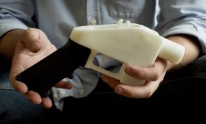 In a photo from 2013, Cody Wilson holds up what he calls a Liberator pistol, which was completely made on a 3-D-printer at his home in Austin, Texas. Eight states filed suit Monday against the Trump administration over its decision to allow a Texas company to publish downloadable blueprints for a 3D-printed gun, contending the hard-to-trace plastic weapons are a boon to terrorists and criminals and threaten public safety. (Jay Janner/Austin American-Statesman via AP, File)