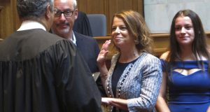 Wisconsin Supreme Court Justice Rebecca Dallet takes a ceremonial oath of office from former Supreme Court Justice Louis Butler in Madison on Monday. Dallet's term officially began last week, but a ceremony was held on Monday in the Assembly chamber. (AP Photo/Scott Bauer)
