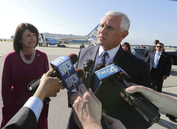 Vice President Mike Pence answers questions from the media while appearing with Republican Senate candidate Leah Vukmir during a stop in Milwaukee on Thursday. Pence was in Milwaukee that night for a closed-door fundraiser to raise money in Wisconsin for Vukmir, who faces the Democrat Tammy Baldwin in the November election. (Rick Wood/Milwaukee Journal-Sentinel via AP)